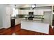 Modern kitchen with granite countertops, stainless steel appliances, and hardwood floors at 7647 Cummings Dr, Mebane, NC 27302