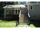 Steps lead up to a deck with glass doors opening to the home's interior at 7647 Cummings Dr, Mebane, NC 27302