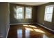 Bright bedroom with hardwood floors and multiple windows at 7647 Cummings Dr, Mebane, NC 27302