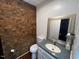 Small bathroom with brick feature wall and sink at 124 Don Ron Rd, Erwin, NC 28339