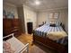 Comfortable bedroom with blue and white bedding and hardwood floors at 124 Don Ron Rd, Erwin, NC 28339