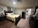 Well-lit bedroom with yellow bedding and dark wood furniture at 124 Don Ron Rd, Erwin, NC 28339