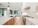 Modern kitchen with white cabinets and a large island with quartz countertops at 1804 Stream Manor Ct, Wake Forest, NC 27587