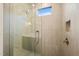 Large walk-in shower with modern fixtures and a window at 1804 Stream Manor Ct, Wake Forest, NC 27587