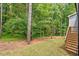 Private backyard with wooden stairs leading to deck at 115 Sanderway Dr, Chapel Hill, NC 27516