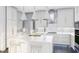 Elegant kitchen boasting white cabinets, gold accents, and a large marble countertop island at 817 Antoine Dr # 5, Durham, NC 27713