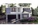 Modern two-story home with gray siding, stone accents, and a black garage door at 816 Antoine Dr # 9, Durham, NC 27713