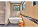 Luxurious bathroom with freestanding tub and wood-like tile at 1312 Hunting Ridge Rd, Raleigh, NC 27615