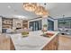 Large kitchen island with a sink, quartz countertop, and seating at 1312 Hunting Ridge Rd, Raleigh, NC 27615