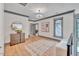Bright hallway with hardwood floors, a dresser, and artwork at 1312 Hunting Ridge Rd, Raleigh, NC 27615
