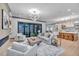 Spacious living area with open floor plan, large windows, and access to backyard patio at 1312 Hunting Ridge Rd, Raleigh, NC 27615