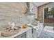 Outdoor kitchen with grill, white countertop, and beverage station at 1312 Hunting Ridge Rd, Raleigh, NC 27615