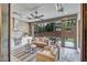 Relaxing outdoor patio with built-in grill, comfortable seating, and screened enclosure at 1312 Hunting Ridge Rd, Raleigh, NC 27615