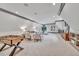 Spacious game room with foosball table, comfortable seating, and built-in shelving at 1312 Hunting Ridge Rd, Raleigh, NC 27615