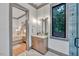 Bathroom with a vanity, shower, and view into a bedroom at 1312 Hunting Ridge Rd, Raleigh, NC 27615