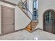 Bright entryway with a modern staircase and hexagonal tile flooring at 1312 Hunting Ridge Rd, Raleigh, NC 27615