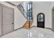 Elegant entryway with a statement staircase, black front door, and hexagonal tile flooring at 1312 Hunting Ridge Rd, Raleigh, NC 27615