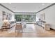 Spacious living area with hardwood floors, large windows, and ample natural light at 1312 Hunting Ridge Rd, Raleigh, NC 27615