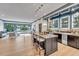 Home bar with granite countertop, dark cabinetry, and glass shelving at 1312 Hunting Ridge Rd, Raleigh, NC 27615