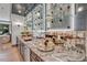 Wet bar with gray cabinetry, quartz countertops, and glass shelving for glassware at 1312 Hunting Ridge Rd, Raleigh, NC 27615