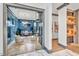Glass-walled home office with herringbone floors and stylish furnishings at 1312 Hunting Ridge Rd, Raleigh, NC 27615