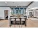 Home bar with granite countertop and glass shelving at 1312 Hunting Ridge Rd, Raleigh, NC 27615