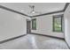 Simple bedroom with grey trim, neutral walls, and two large windows at 1312 Hunting Ridge Rd, Raleigh, NC 27615