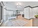 Open and bright hallway with modern chandelier and stylish rug at 1312 Hunting Ridge Rd, Raleigh, NC 27615