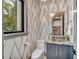 Stylish powder room features a modern sink, toilet, and geometric wallpaper at 1312 Hunting Ridge Rd, Raleigh, NC 27615