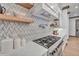 Stylish kitchen with gas stove and wave patterned backsplash at 1312 Hunting Ridge Rd, Raleigh, NC 27615