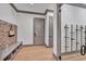 Stylish mudroom with built-in bench, wine storage, and herringbone patterned wall at 1312 Hunting Ridge Rd, Raleigh, NC 27615