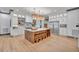 Modern kitchen with large island, stainless steel appliances, and hardwood floors at 1312 Hunting Ridge Rd, Raleigh, NC 27615