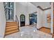 Elegant entryway with hexagonal tile floor and modern staircase at 1312 Hunting Ridge Rd, Raleigh, NC 27615