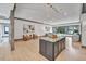 Open-concept kitchen with large island, dark cabinetry, and granite countertops at 1312 Hunting Ridge Rd, Raleigh, NC 27615