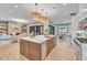 Open concept kitchen with large island, stainless steel appliances, and hardwood floors at 1312 Hunting Ridge Rd, Raleigh, NC 27615