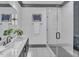 Clean bathroom with marble countertop, a frameless shower, and dark vanity at 1312 Hunting Ridge Rd, Raleigh, NC 27615