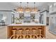 Modern kitchen with a large island and statement lighting at 1312 Hunting Ridge Rd, Raleigh, NC 27615