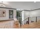 Bright hallway with hardwood floors and modern chandelier at 1312 Hunting Ridge Rd, Raleigh, NC 27615