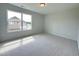 Bright bedroom with carpeted floor and a large window at 73 Sage Ln # 008, Four Oaks, NC 27524