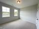 Well-lit bedroom featuring neutral walls and carpet at 73 Sage Ln # 008, Four Oaks, NC 27524