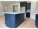 Kitchen island with white quartz countertop and dark blue cabinets at 73 Sage Ln # 008, Four Oaks, NC 27524