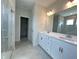 Double vanity bathroom with walk-in shower and access to closet at 73 Sage Ln # 008, Four Oaks, NC 27524