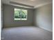 Bright bedroom featuring a large window and plush carpeting at 73 Sage Ln # 008, Four Oaks, NC 27524