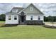 Charming two-story home with stone accents and a welcoming front porch at 73 Sage Ln # 008, Four Oaks, NC 27524