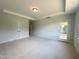 Spacious bedroom with carpeting, double doors, and access to a private patio at 73 Sage Ln # 008, Four Oaks, NC 27524