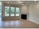 Bright living room featuring a fireplace and plenty of natural light at 73 Sage Ln # 008, Four Oaks, NC 27524