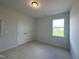 Spacious bedroom with double doors and a large window at 73 Sage Ln # 008, Four Oaks, NC 27524