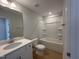 Clean bathroom featuring a bathtub, toilet and vanity with white cabinets at 73 Sage Ln # 008, Four Oaks, NC 27524
