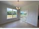 Dining area with hardwood floors, large windows, and access to deck at 73 Sage Ln # 008, Four Oaks, NC 27524