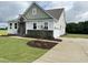 Two-story home with stone accents, landscaping, and a two-car garage at 73 Sage Ln # 008, Four Oaks, NC 27524